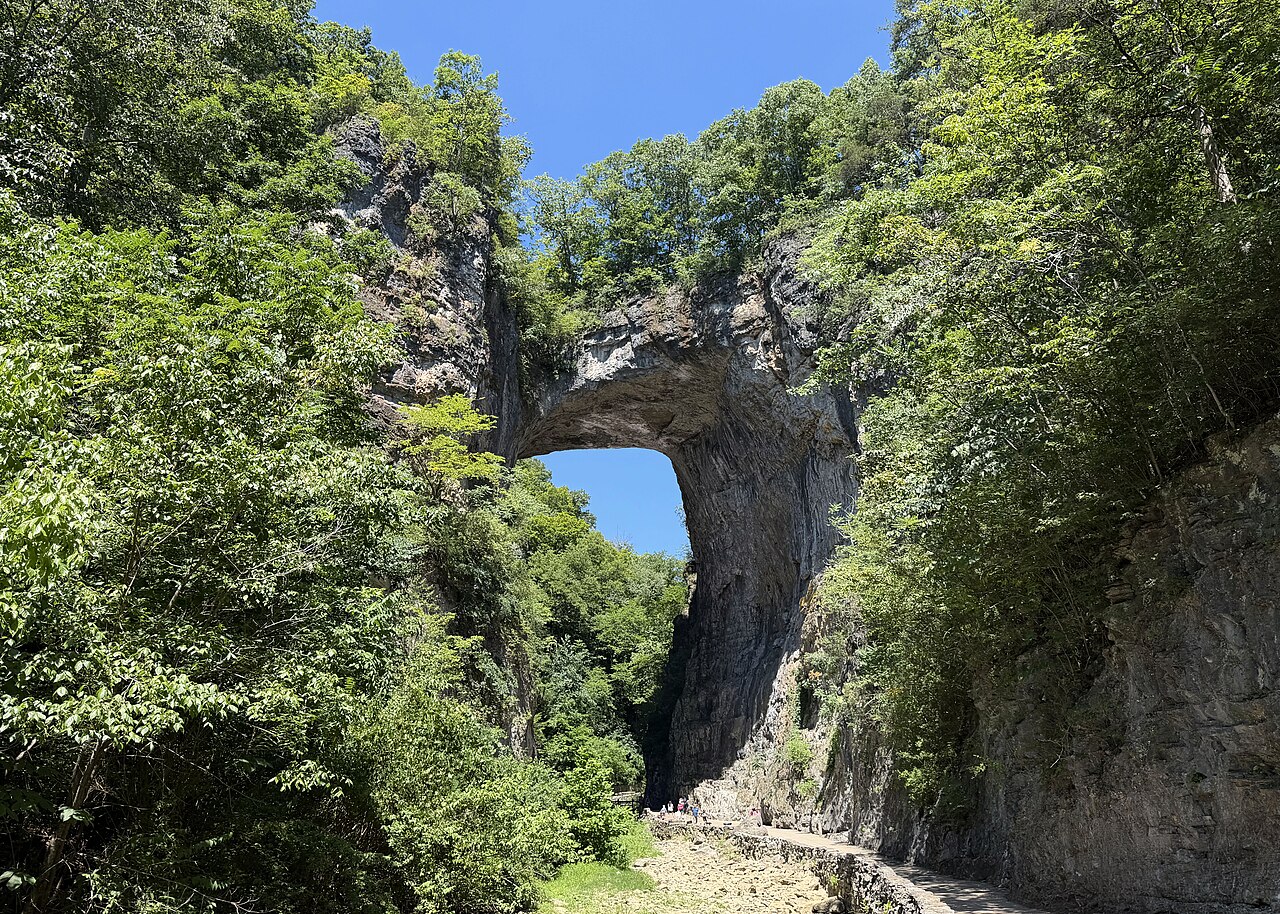 A natural stone arch in a green gorge